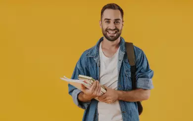 image-content-student-guy-denim-clothes-smiling-while-holding-exercise-books-isolated-yellow-wall 1 (convert.io)